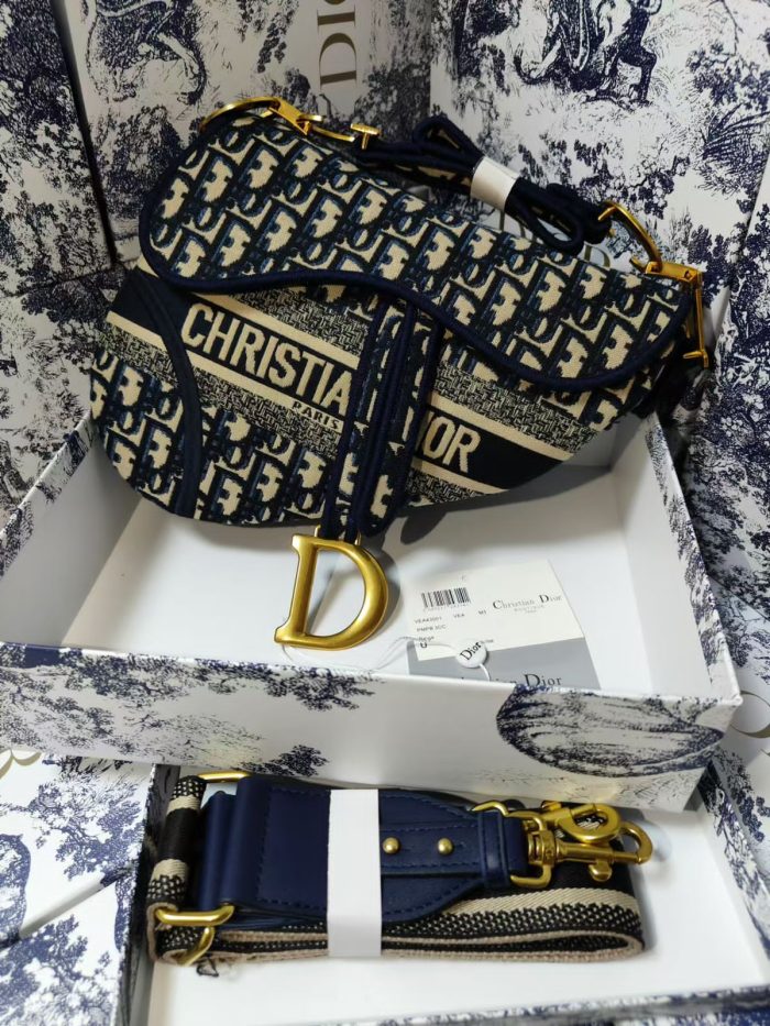 Christian Dior Oblique Saddle bag in blue canvas with an additional strap and gold-tone hardware.