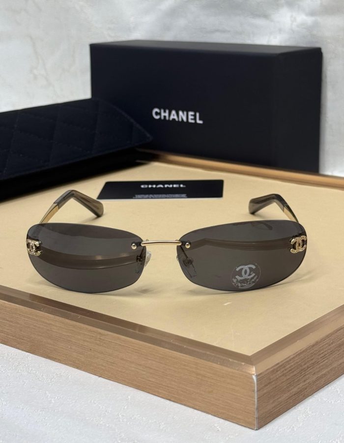 Chanel Gold And Black  Lens Rimless Sunglasses With A Crystal CC Logo