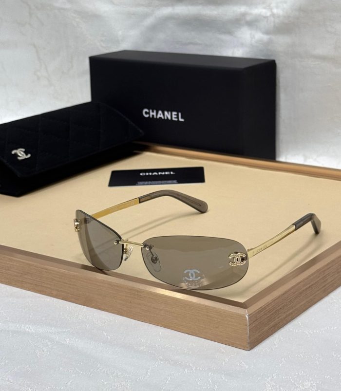 Chanel Gold And Gray Lens Rimless Sunglasses With A Crystal CC Logo