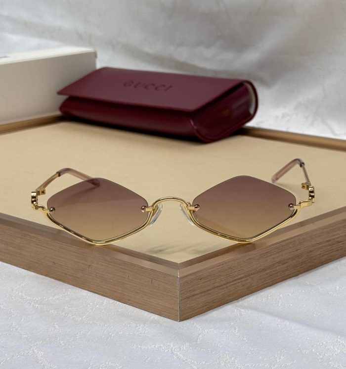 Gucci GG1604S Rimless Sunglasses With A Gold Metal Frame And Brown Lenses