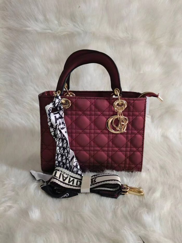 Dior Lady Dior bag in a Burgundy color with cannage quilting and gold-finish metal D.I.O.R. charms