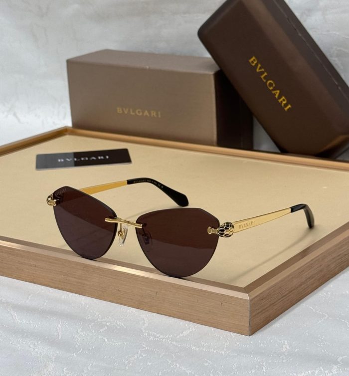 Bvlgari Sunglasses With A  Gold Frame And Brown Gradient Lenses