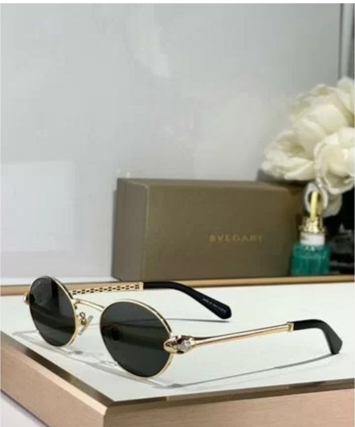 Bvlgari Round Metal Sunglasses With A Gold Frame And Black Mirror Lenses