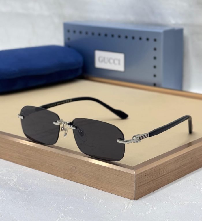 Gucci GG1221S Men's Rimless Sunglasses With Sliver Metal Frames And Black Lenses.